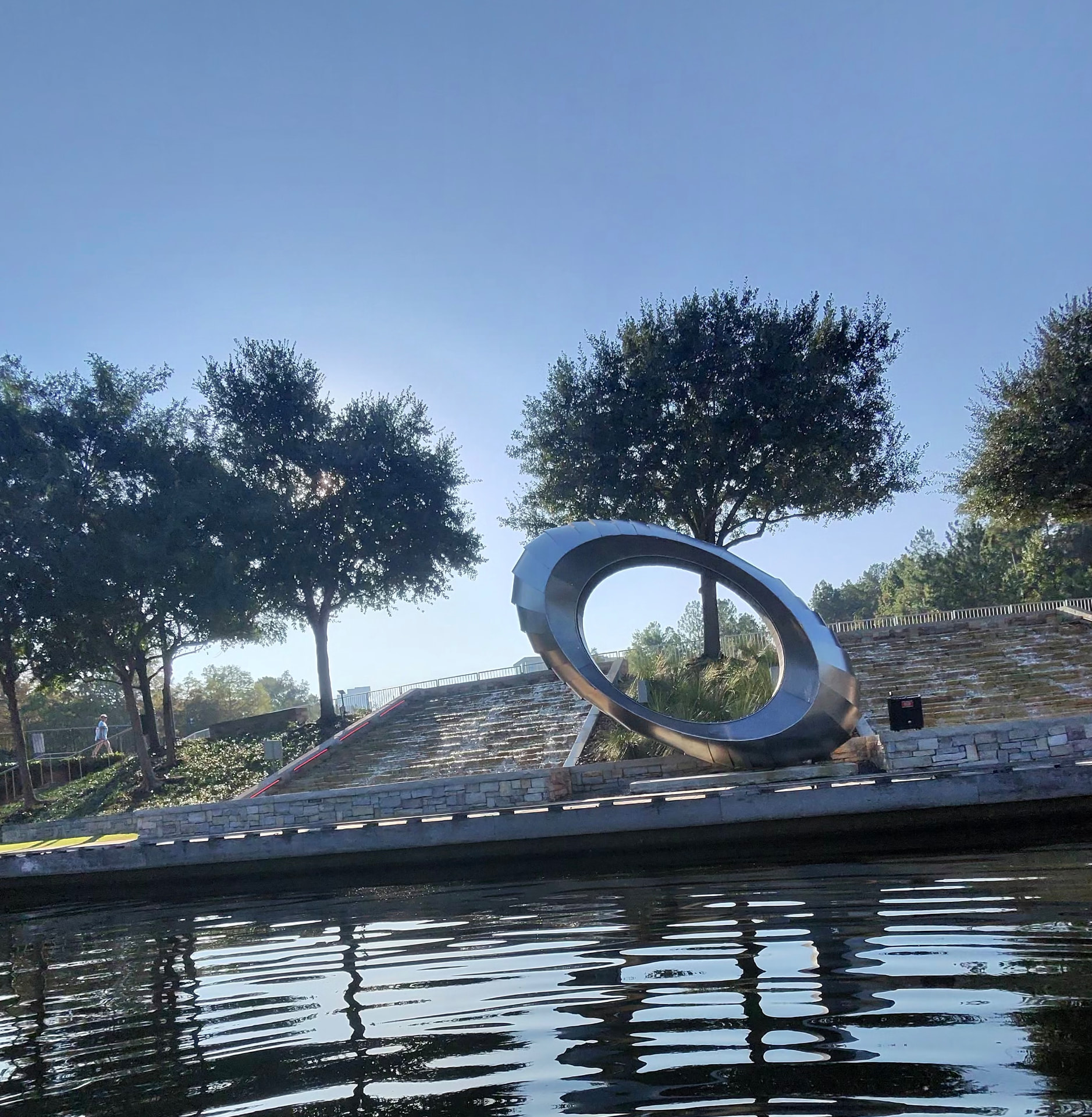 Calm water and trees reflected at The Woodlands Boathouse in The Woodlands, TX, where Gen Zen teaches paddleboard lessons